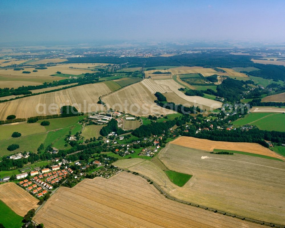 Oberschöna from the bird's eye view: Agricultural land and field boundaries surround the settlement area of the village in Oberschöna in the state Saxony, Germany