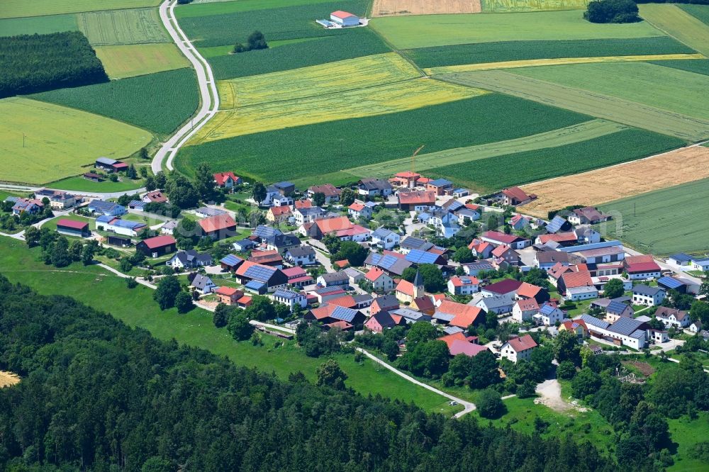 Oening from above - Agricultural land and field boundaries surround the settlement area of the village in Oening in the state Bavaria, Germany