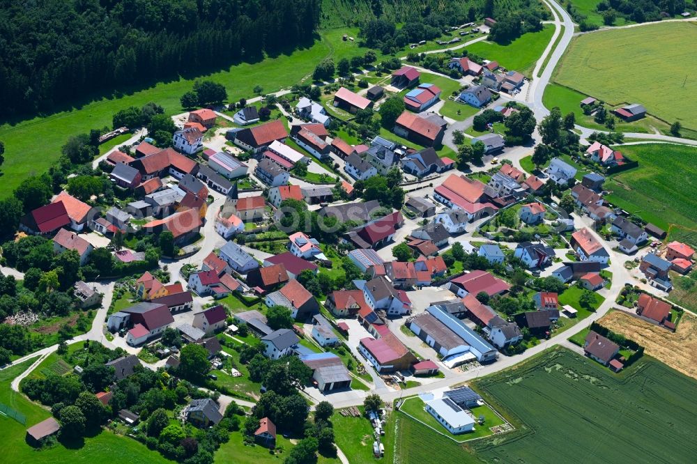 Oening from above - Agricultural land and field boundaries surround the settlement area of the village in Oening in the state Bavaria, Germany