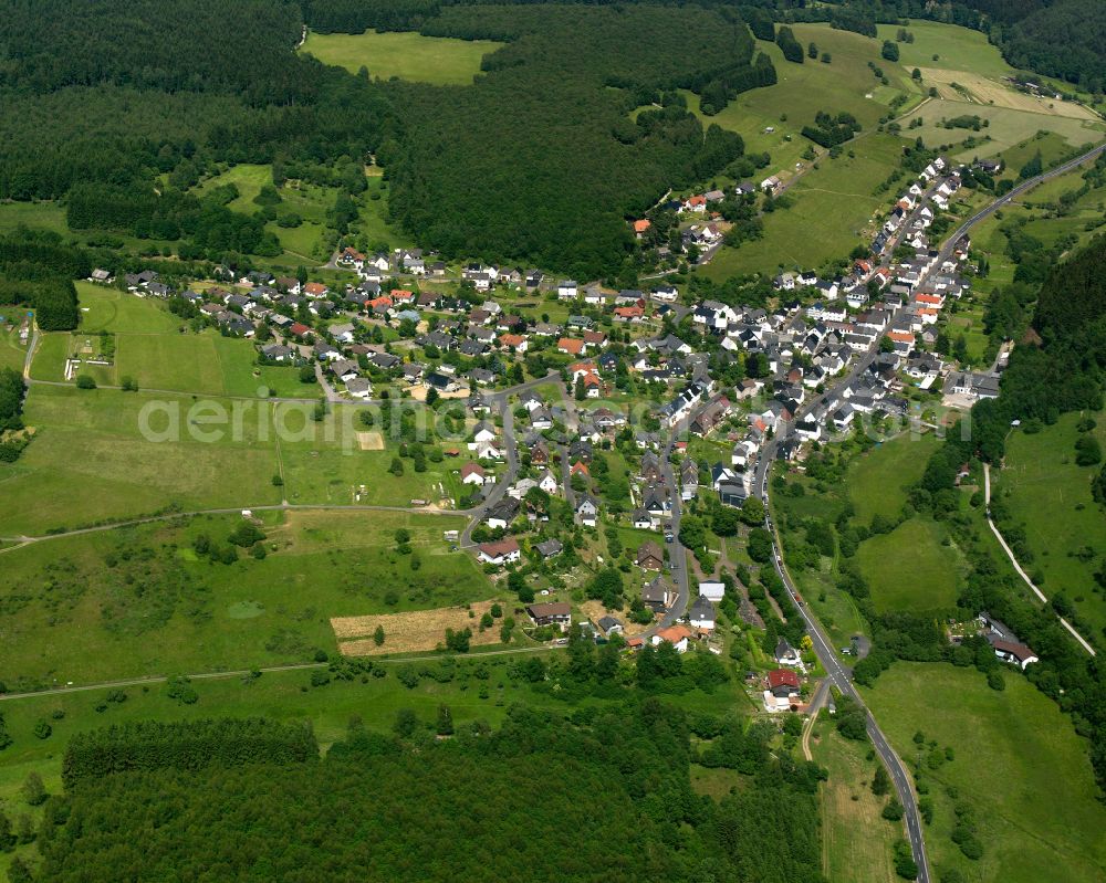 Aerial image Offdilln - Agricultural land and field boundaries surround the settlement area of the village in Offdilln in the state Hesse, Germany