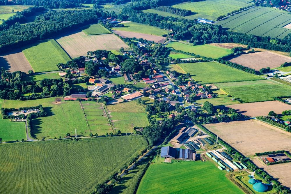 Ohrensen from above - Agricultural land and field boundaries surround the settlement area of the village in Ohrensen in the state Lower Saxony, Germany