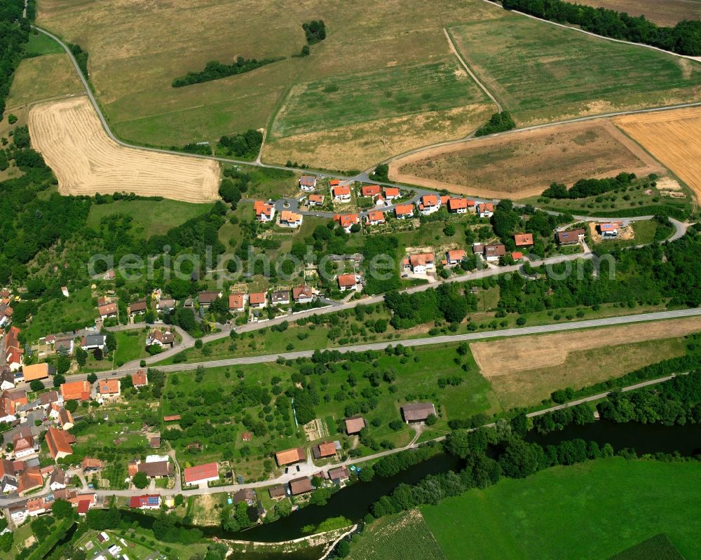 Olnhausen from above - Agricultural land and field boundaries surround the settlement area of the village in Olnhausen in the state Baden-Wuerttemberg, Germany