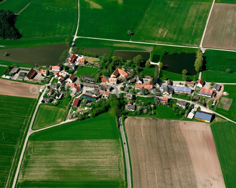 Petersaurach from above - Agricultural land and field boundaries surround the settlement area of the village in Petersaurach in the state Bavaria, Germany
