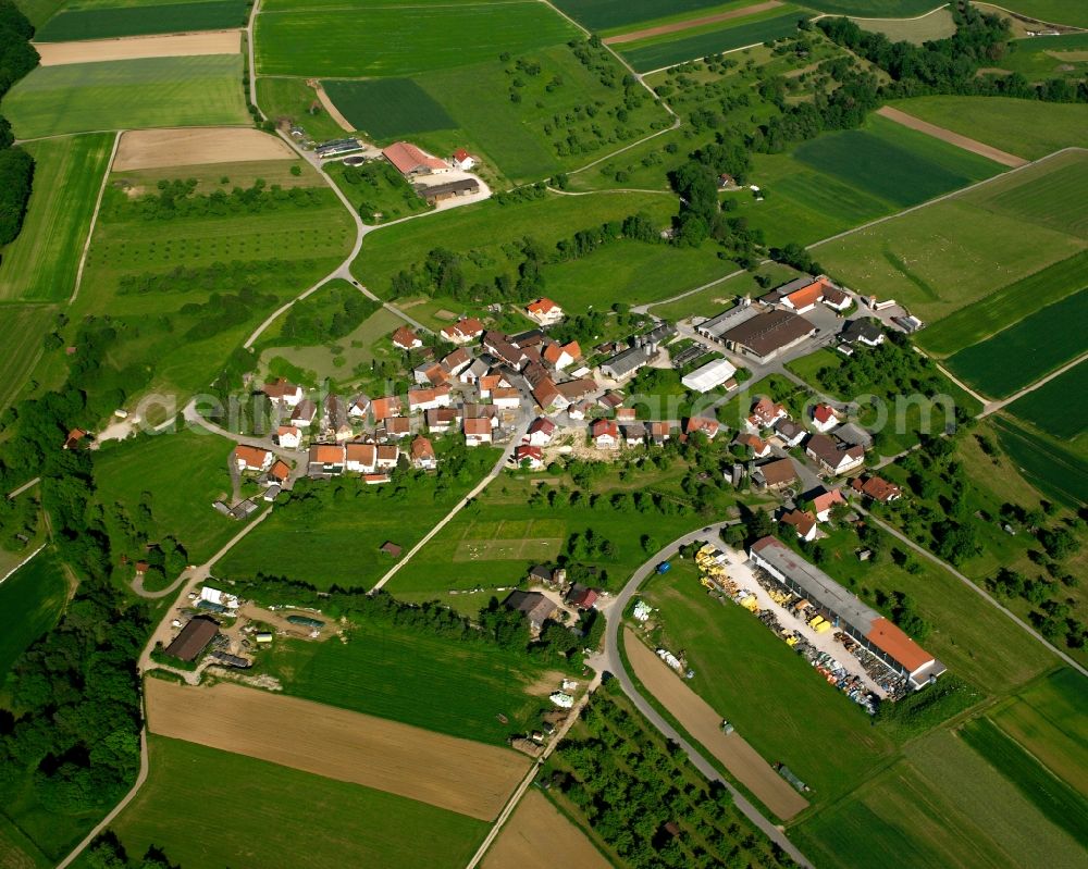 Pliensbach from above - Agricultural land and field boundaries surround the settlement area of the village in Pliensbach in the state Baden-Wuerttemberg, Germany