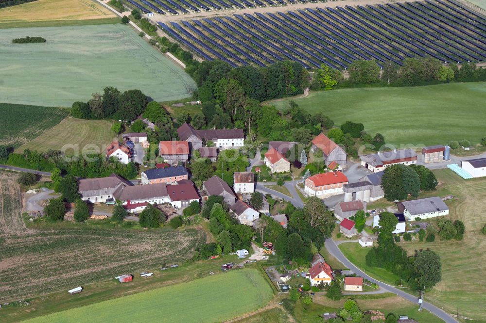 Preußling from above - Agricultural land and field boundaries surround the settlement area of the village in Preussling in the state Bavaria, Germany