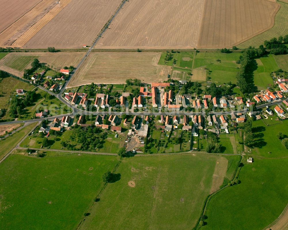 Quersa from above - Agricultural land and field boundaries surround the settlement area of the village in Quersa in the state Saxony, Germany