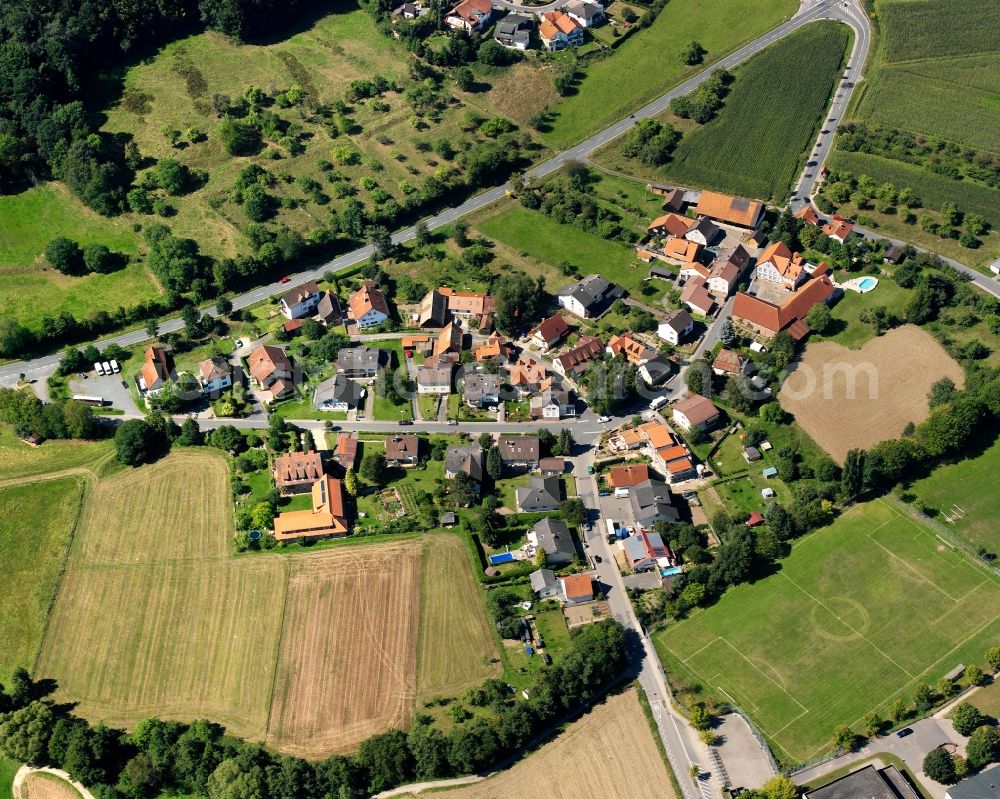 Rai-Breitenbach from the bird's eye view: Agricultural land and field boundaries surround the settlement area of the village in Rai-Breitenbach in the state Hesse, Germany
