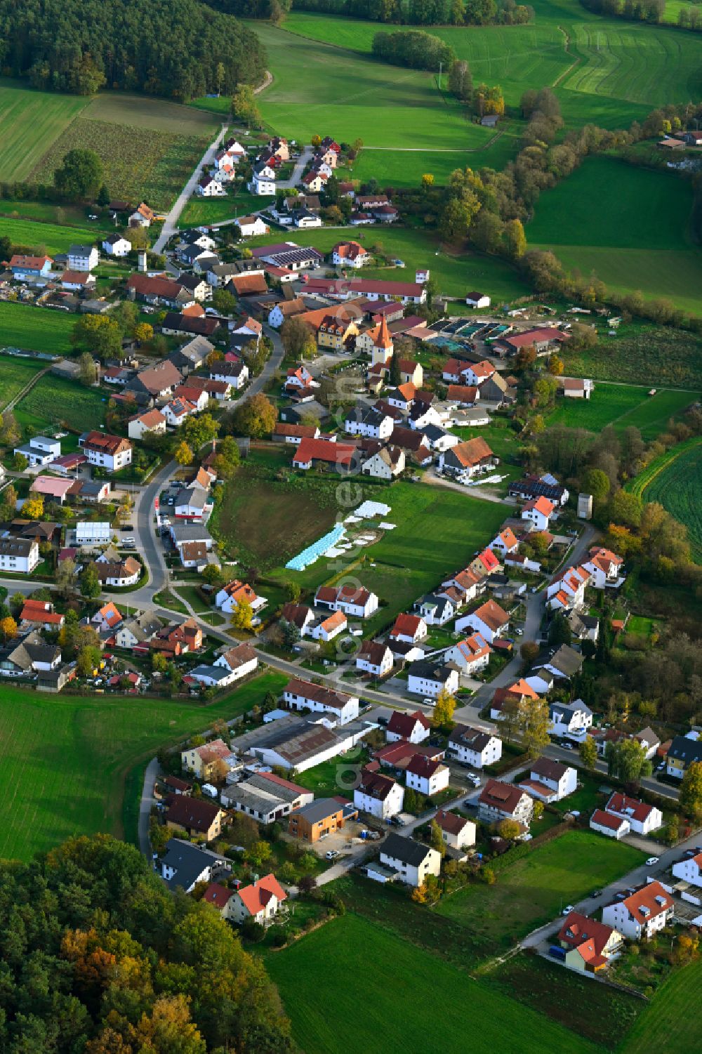 Richtheim from above - Agricultural land and field boundaries surround the settlement area of the village in Richtheim in the state Bavaria, Germany