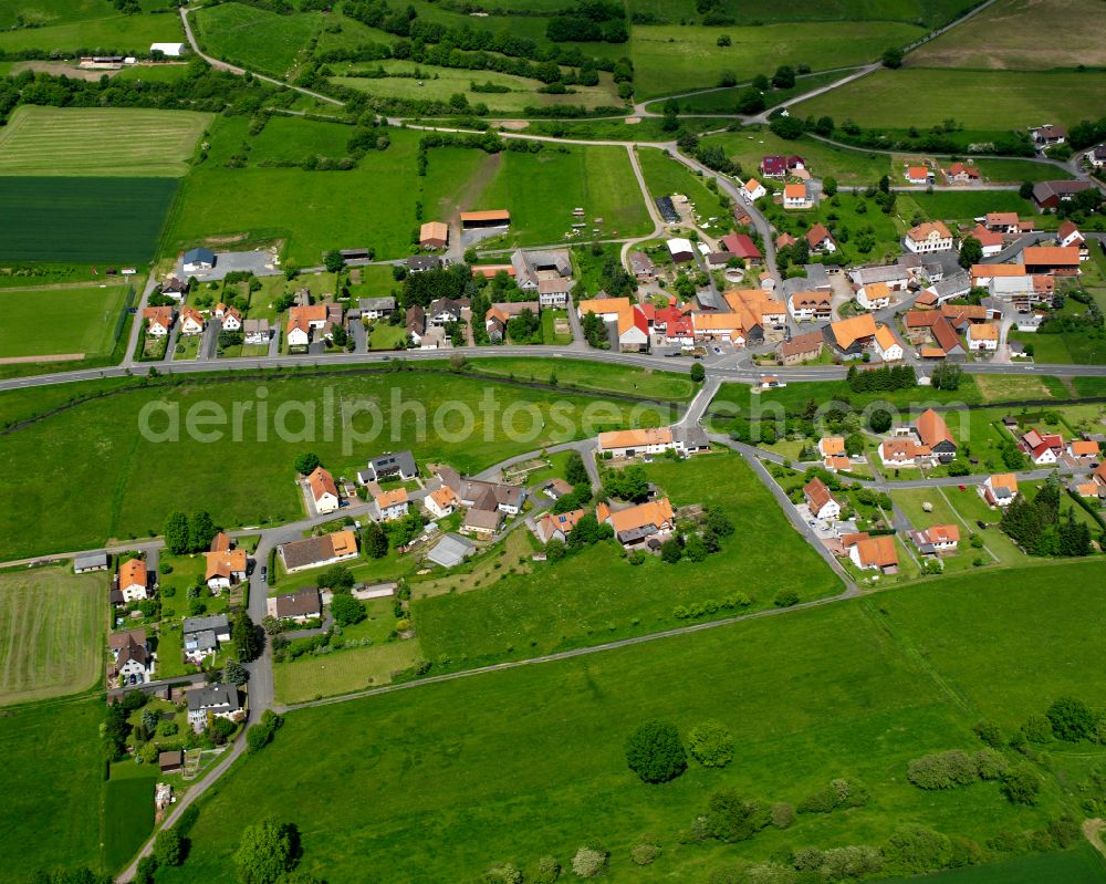 Rixfeld from above - Agricultural land and field boundaries surround the settlement area of the village in Rixfeld in the state Hesse, Germany