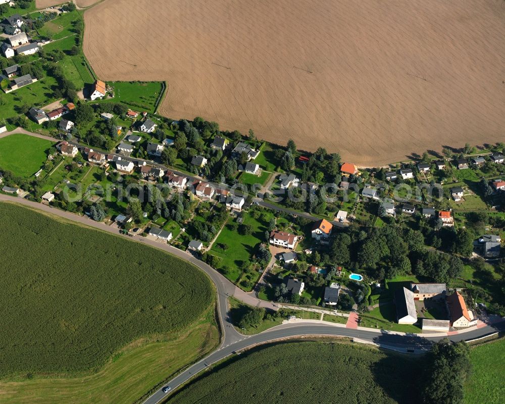 Sachsenburg from above - Agricultural land and field boundaries surround the settlement area of the village in Sachsenburg in the state Saxony, Germany
