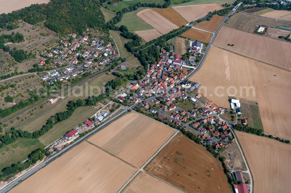 Aerial photograph Sachsenheim - Agricultural land and field boundaries surround the settlement area of the village in Sachsenheim in the state Bavaria, Germany