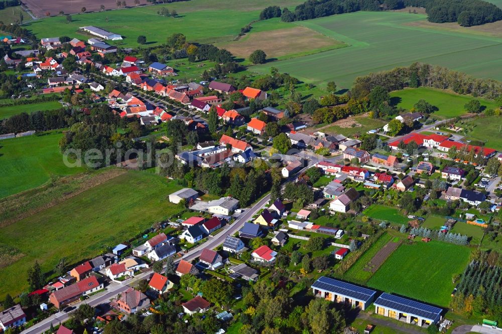 Aerial photograph Sadenbeck - Agricultural land and field boundaries surround the settlement area of the village in Sadenbeck in the state Brandenburg, Germany