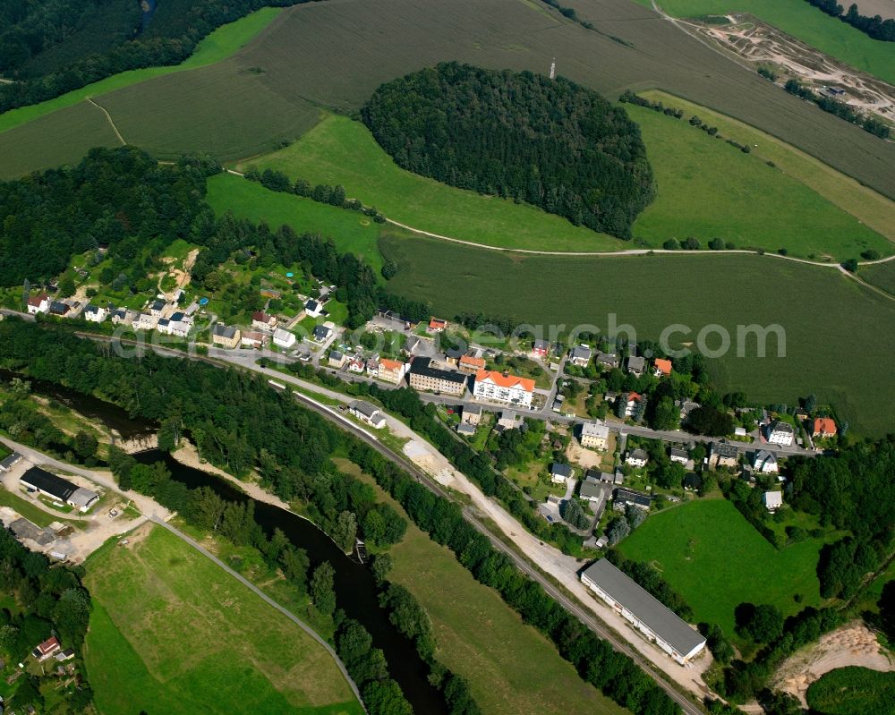 Schellenberg from above - Agricultural land and field boundaries surround the settlement area of the village in Schellenberg in the state Saxony, Germany