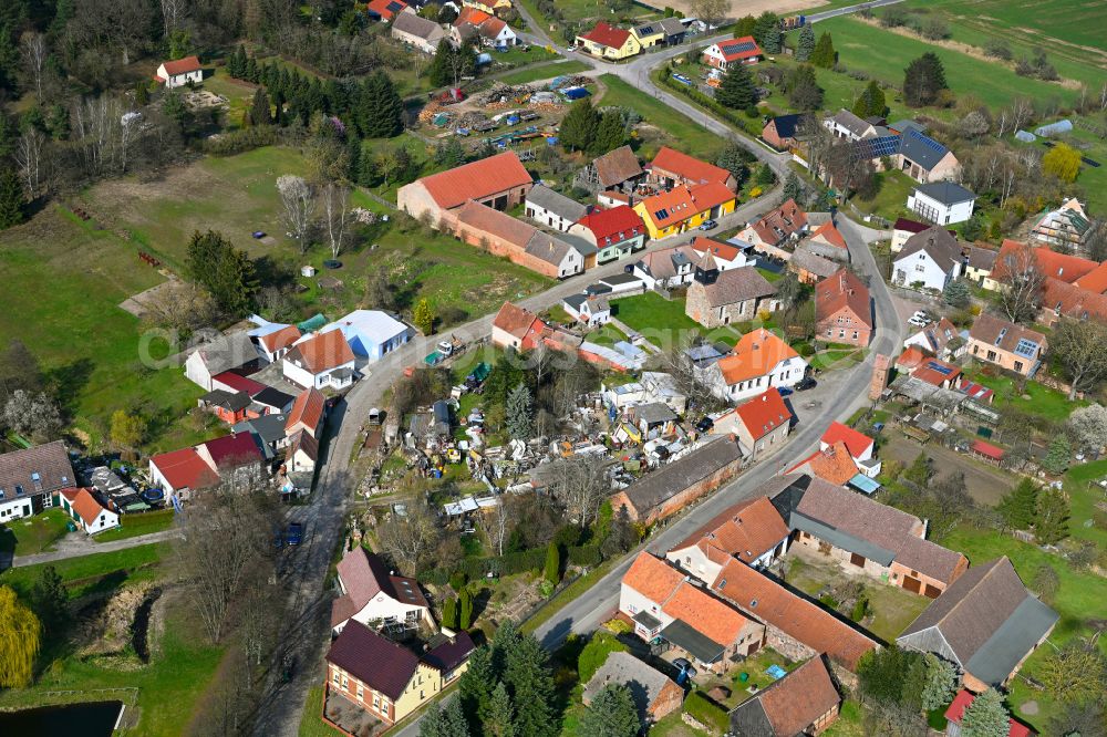 Schlamau from the bird's eye view: Agricultural land and field boundaries surround the settlement area of the village in Schlamau in the state Brandenburg, Germany