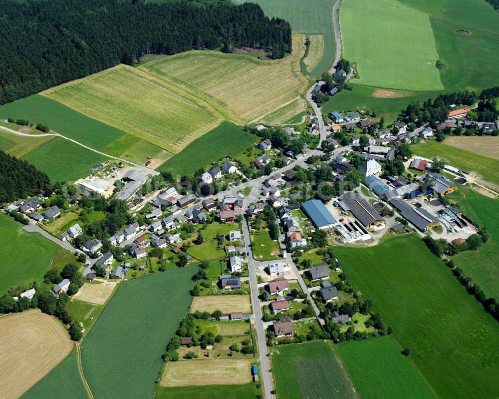 Schlegel from above - Agricultural land and field boundaries surround the settlement area of the village in Schlegel in the state Bavaria, Germany