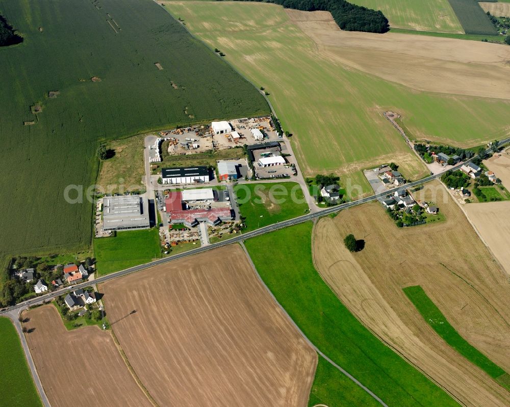 Schlegel from above - Agricultural land and field boundaries surround the settlement area of the village in Schlegel in the state Saxony, Germany