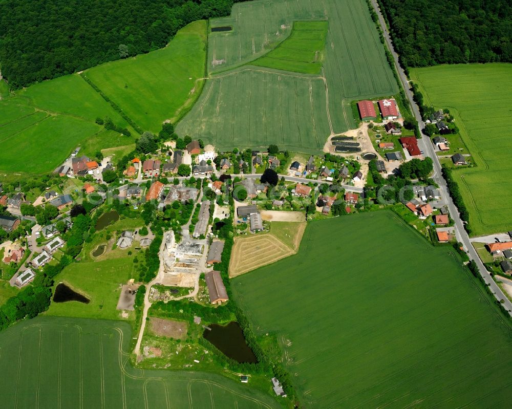 Aerial image Schönberg - Agricultural land and field boundaries surround the settlement area of the village in Schönberg in the state Schleswig-Holstein, Germany
