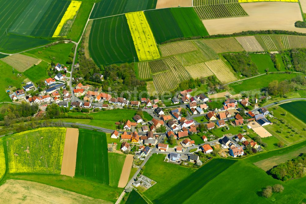 Schnepfenbach from above - Agricultural land and field boundaries surround the settlement area of the village in Schnepfenbach in the state Bavaria, Germany