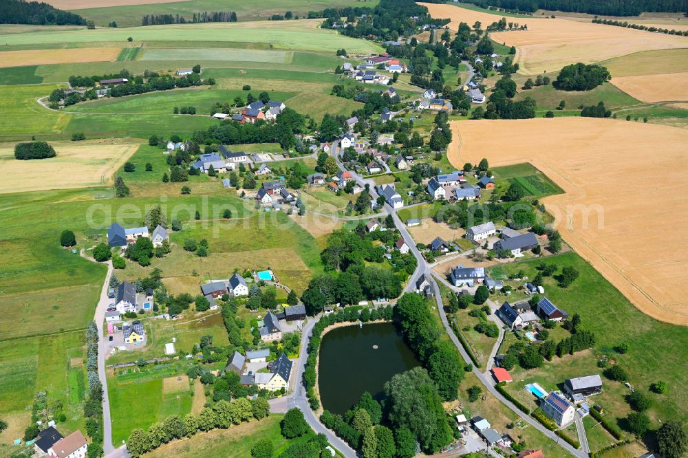 Schönerstadt from above - Agricultural land and field boundaries surround the settlement area of the village in Schönerstadt in the state Saxony, Germany