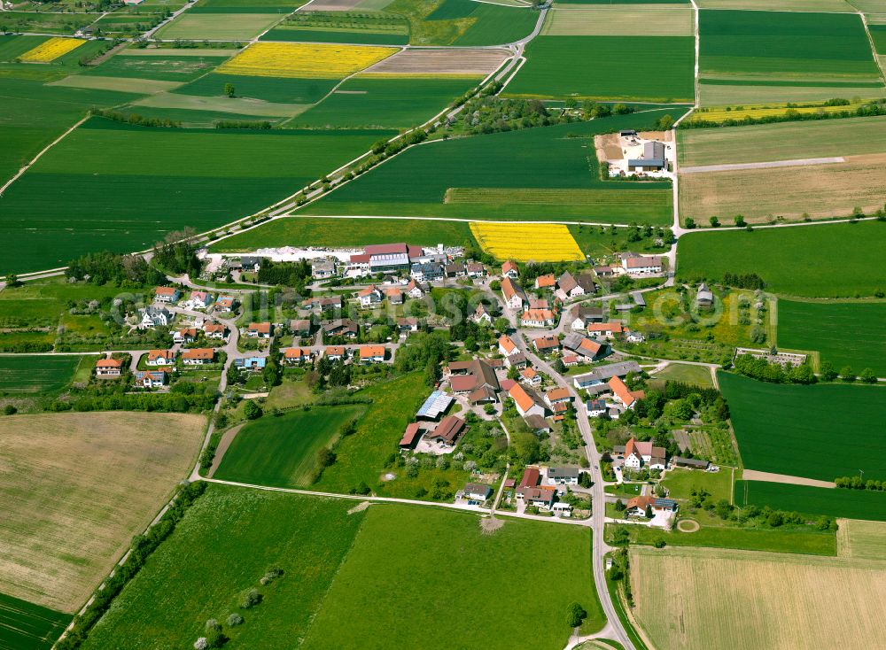 Schwörzkirch from above - Agricultural land and field boundaries surround the settlement area of the village in Schwörzkirch in the state Baden-Wuerttemberg, Germany