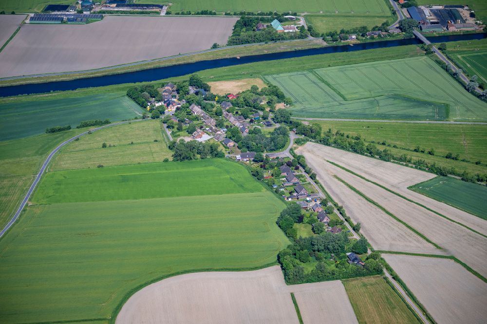 Dagebüll from above - Agricultural land and field boundaries surround the settlement area of the village Sueder-Waygaart in Dagebuell North Friesland in the state Schleswig-Holstein, Germany