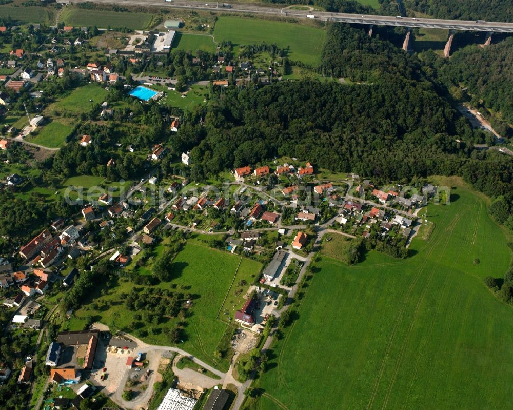 Siebenlehn from above - Agricultural land and field boundaries surround the settlement area of the village in Siebenlehn in the state Saxony, Germany