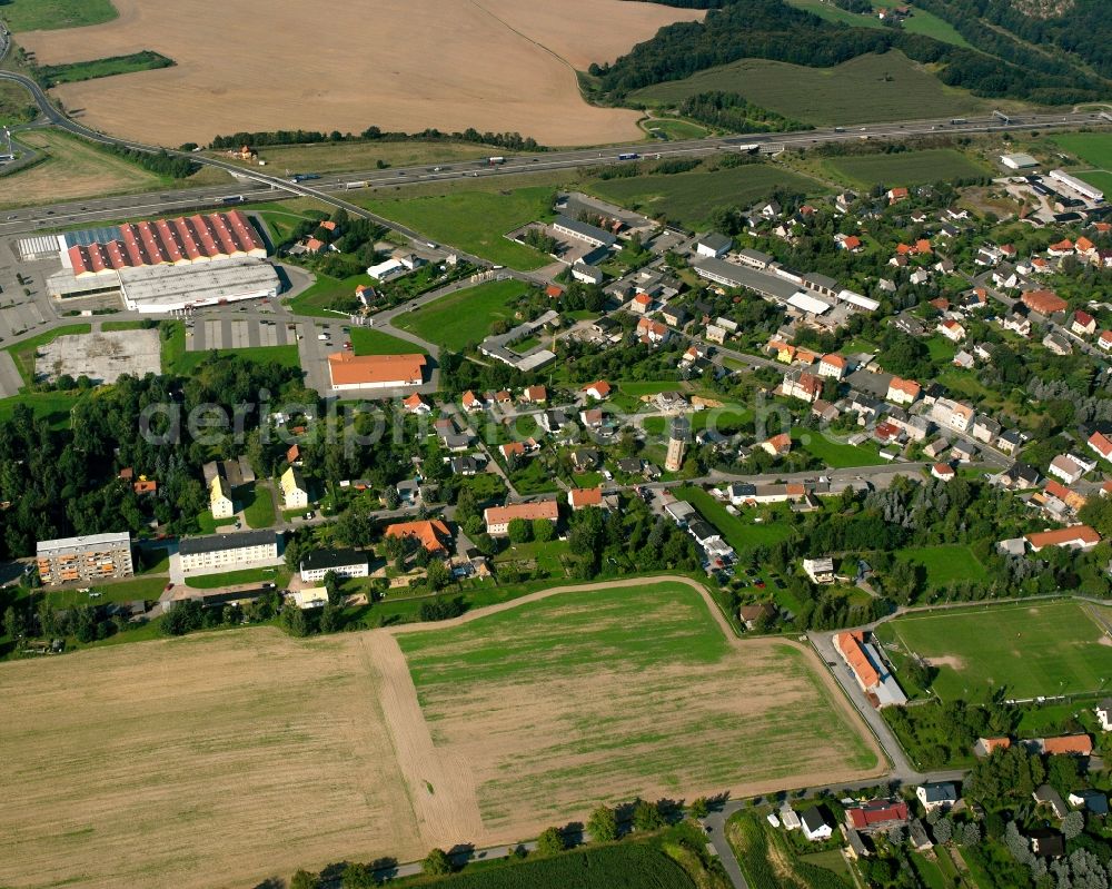Siebenlehn from the bird's eye view: Agricultural land and field boundaries surround the settlement area of the village in Siebenlehn in the state Saxony, Germany
