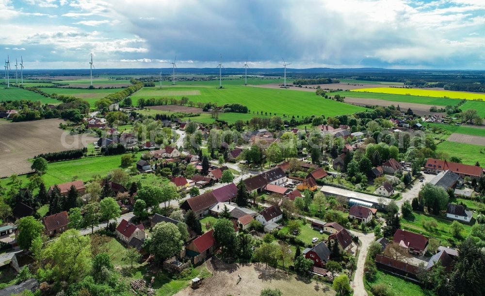 Sieversdorf from the bird's eye view: Agricultural land and field boundaries surround the settlement area of the village in Sieversdorf in the state Brandenburg, Germany
