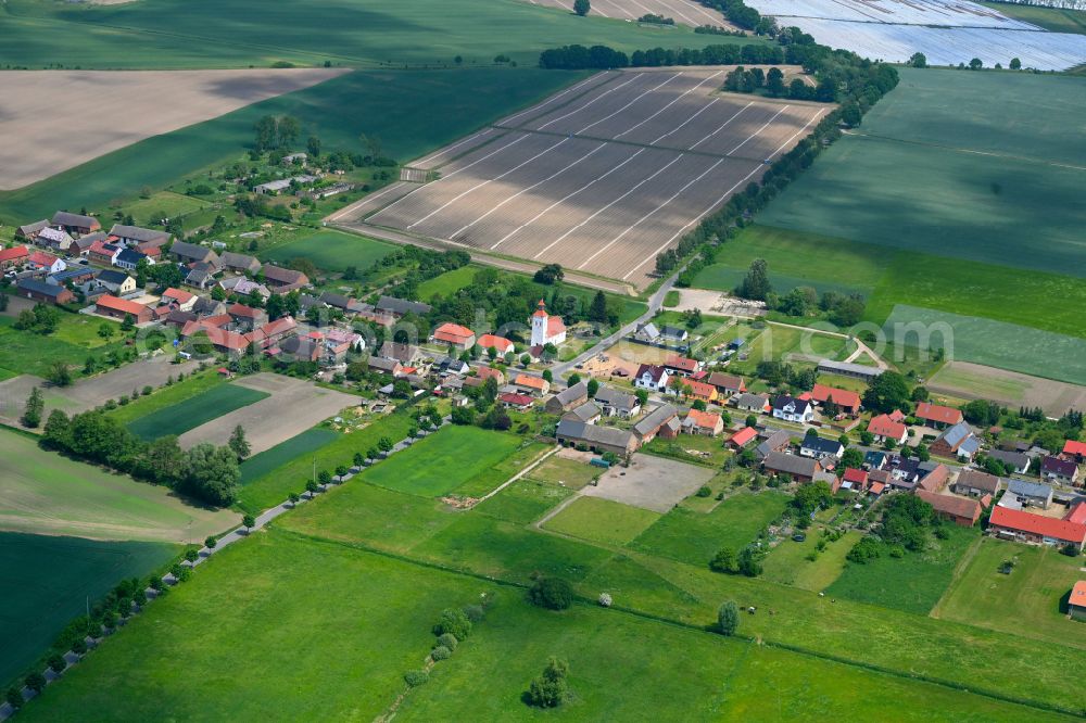 Aerial image Sonnenberg - Agricultural land and field boundaries surround the settlement area of the village in Sonnenberg in the state Brandenburg, Germany