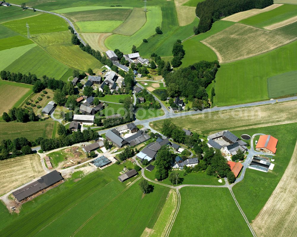 Stobersreuth from above - Agricultural land and field boundaries surround the settlement area of the village in Stobersreuth in the state Bavaria, Germany