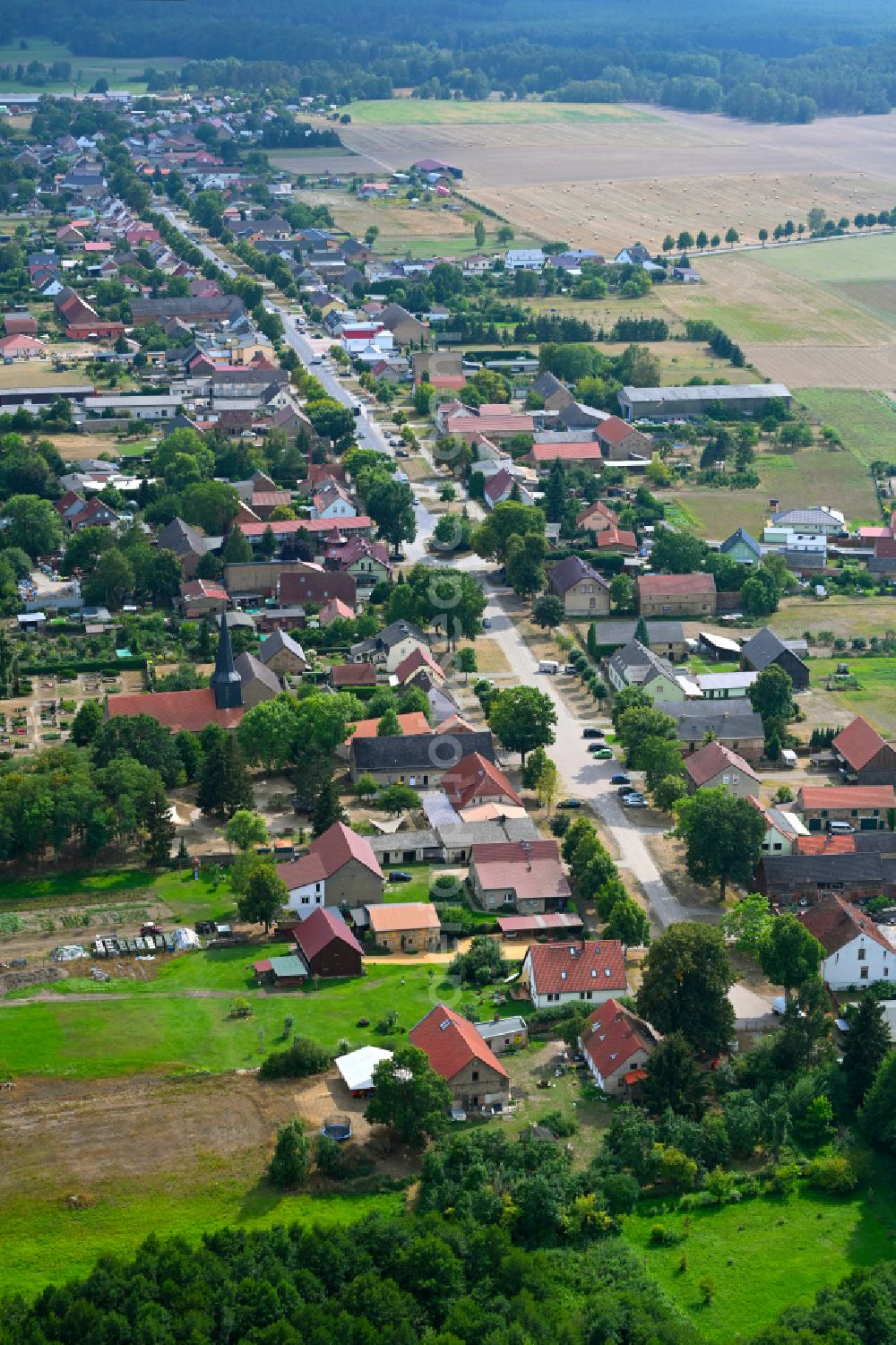 Teschendorf from the bird's eye view: Agricultural land and field boundaries surround the settlement area of the village in Teschendorf Loewenberger Land in the state Brandenburg, Germany