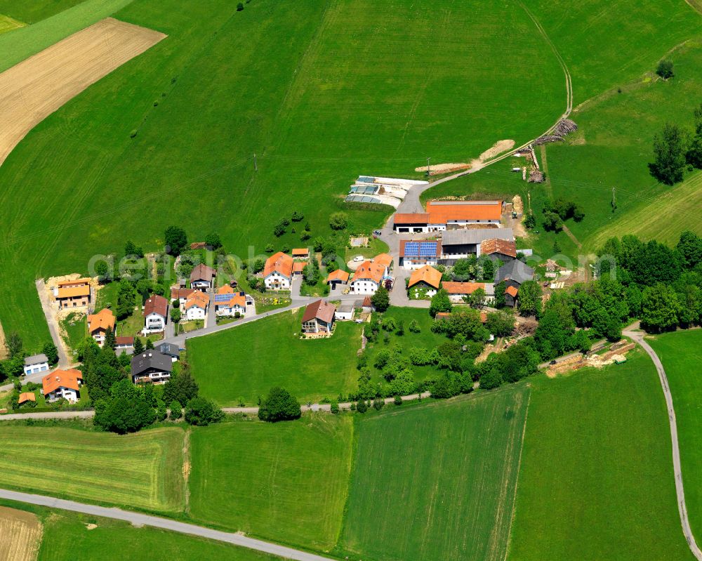 Traxing from the bird's eye view: Agricultural land and field boundaries surround the settlement area of the village in Traxing in the state Bavaria, Germany