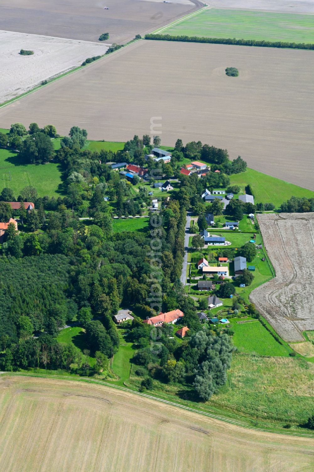 Turow from above - Agricultural land and field boundaries surround the settlement area of the village in Turow in the state Mecklenburg - Western Pomerania, Germany