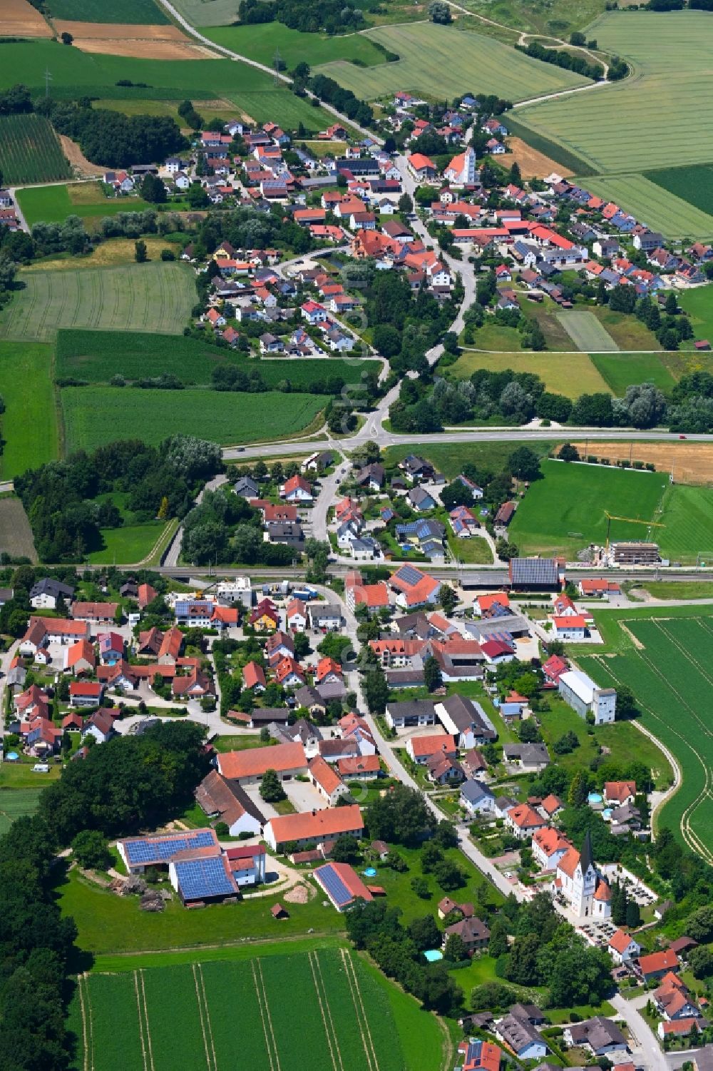 Uttenhofen from above - Agricultural land and field boundaries surround the settlement area of the village in Uttenhofen in the state Bavaria, Germany
