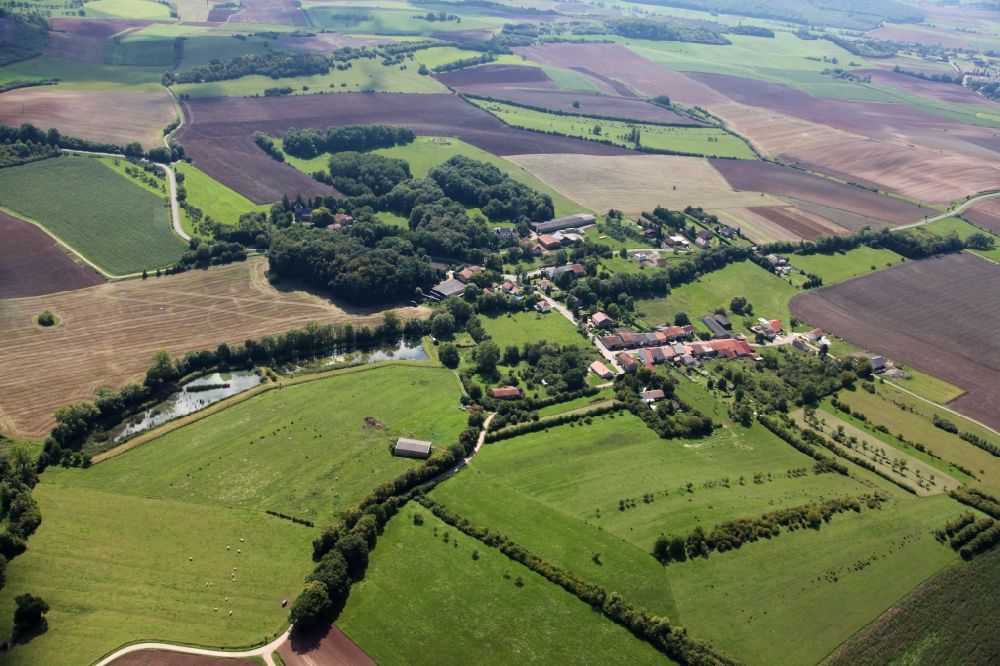Valmunster from above - Agricultural land and field boundaries surround the settlement area of the village in Valmunster in Grand Est, France
