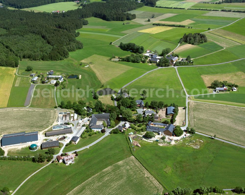 Völkenreuth from above - Agricultural land and field boundaries surround the settlement area of the village in Völkenreuth in the state Bavaria, Germany