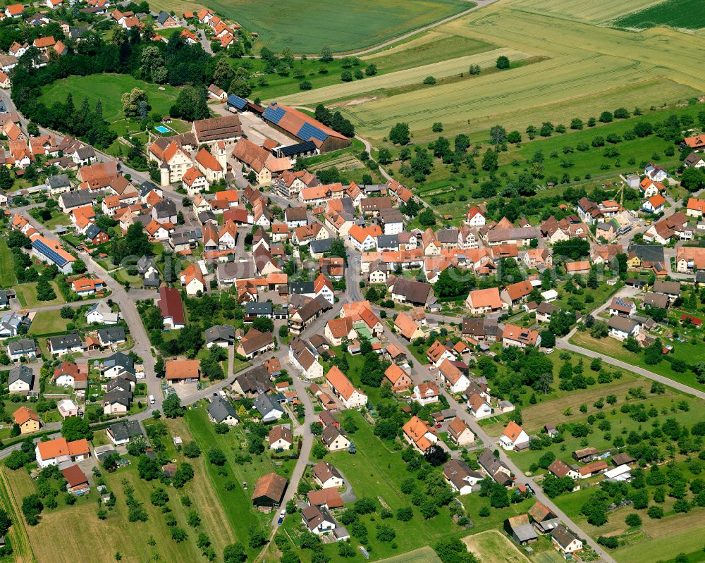 Wachendorf from above - Agricultural land and field boundaries surround the settlement area of the village in Wachendorf in the state Baden-Wuerttemberg, Germany