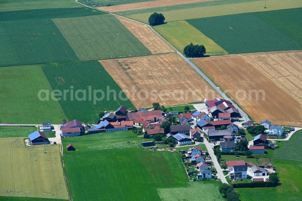 Wackersberg from above - Agricultural land and field boundaries surround the settlement area of the village in Wackersberg in the state Bavaria, Germany