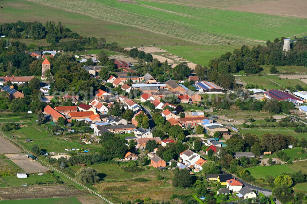 Weesow from above - Agricultural land and field boundaries surround the settlement area of the village in Weesow in the state Brandenburg, Germany
