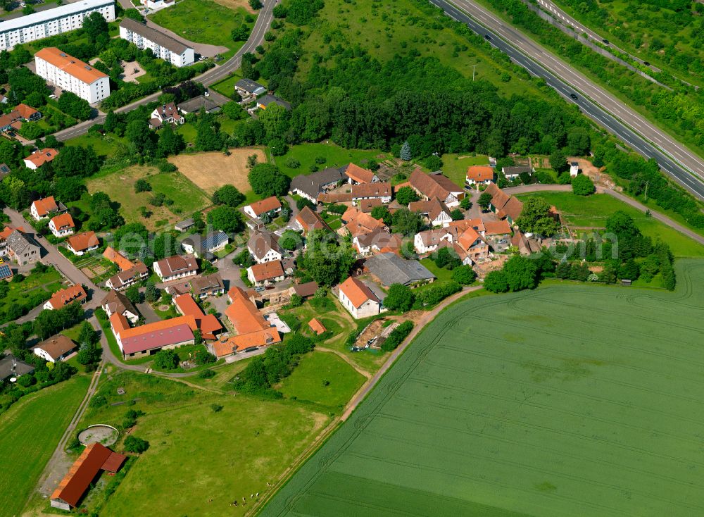Weierhof from above - Agricultural land and field boundaries surround the settlement area of the village in Weierhof in the state Rhineland-Palatinate, Germany