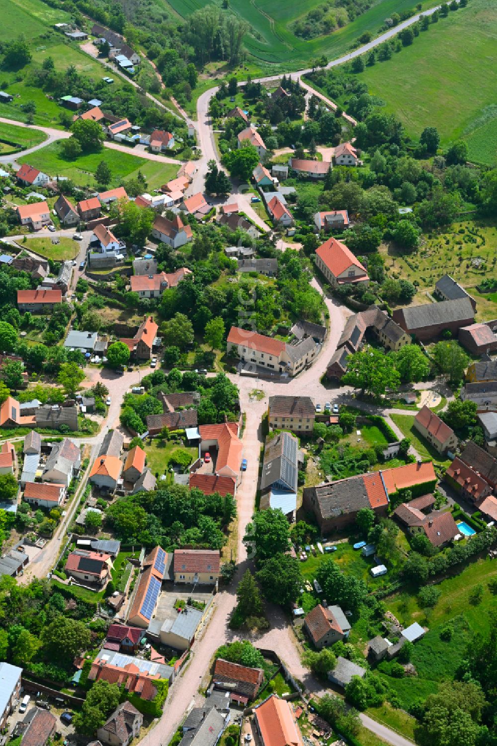 Wettin from above - Agricultural land and field boundaries surround the settlement area of the village in Wettin in the state Saxony-Anhalt, Germany