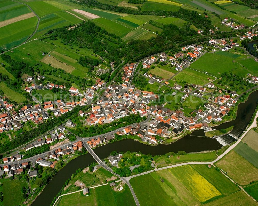 Aerial photograph Widdershausen - Agricultural land and field boundaries surround the settlement area of the village in Widdershausen in the state Hesse, Germany