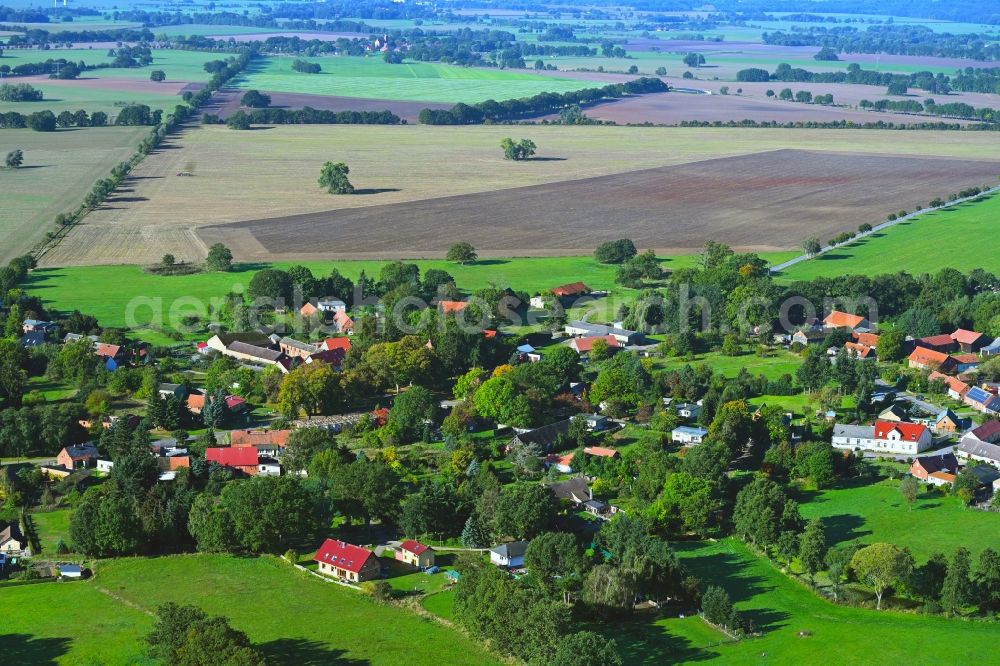 Wilmersdorf from the bird's eye view: Agricultural land and field boundaries surround the settlement area of the village in Wilmersdorf in the state Brandenburg, Germany