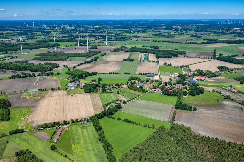 Wohlerst from the bird's eye view: Agricultural land and field boundaries surround the settlement area of the village in Wohlerst in the state Lower Saxony, Germany