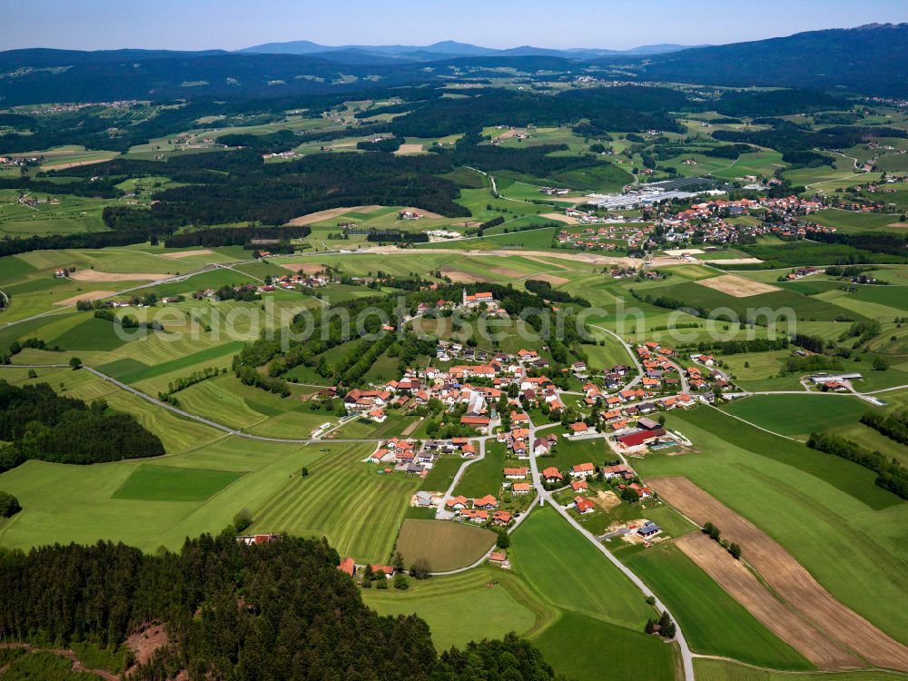 Wollaberg from above - Agricultural land and field boundaries surround the settlement area of the village in Wollaberg in the state Bavaria, Germany