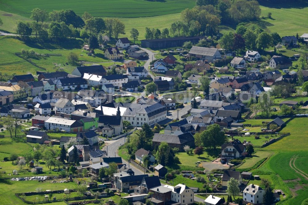 Zollgrün from above - Agricultural land and field boundaries surround the settlement area of the village in Zollgruen in the state Thuringia, Germany