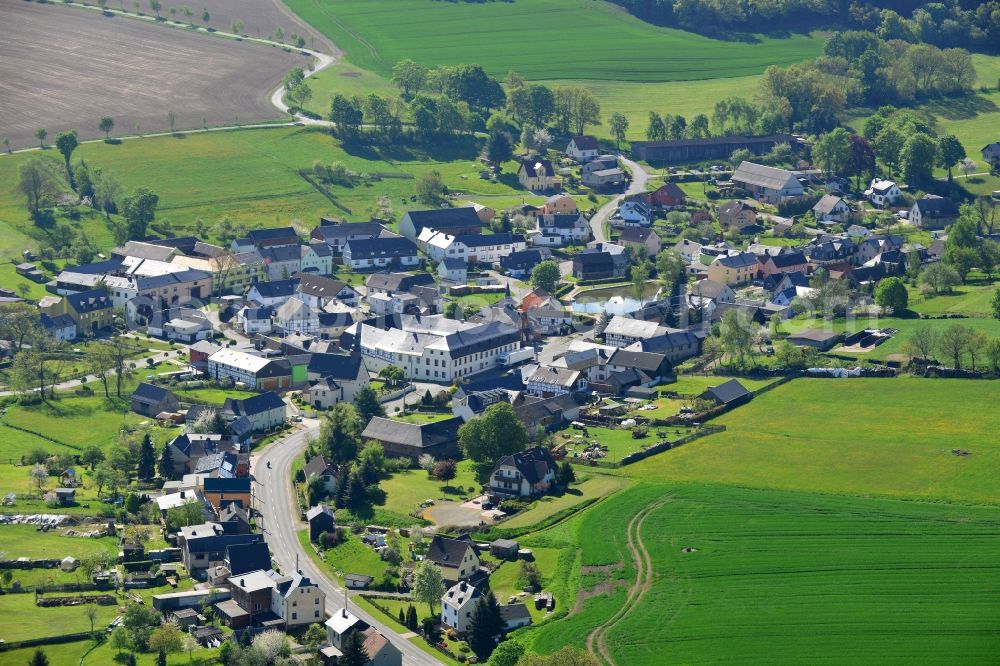 Zollgrün from above - Agricultural land and field boundaries surround the settlement area of the village in Zollgruen in the state Thuringia, Germany