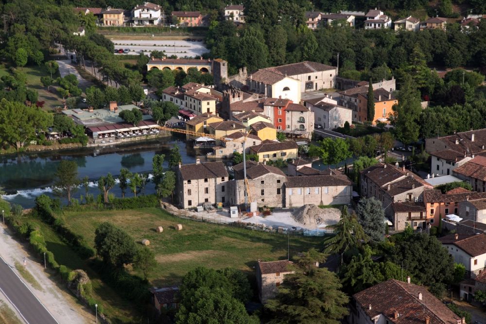Valeggio sul Mincio from above - Village on the river bank areas of Mincio in the district Borghetto in Valeggio sul Mincio in Veneto, Italy. The picturesque district of Borghetto is one of the most beautiful villages in Italy. Borghetto used to be a fishing village. It has become a popular tourist destination. There are various restaurants and bars. Noteworthy are the watermills, some of which are still in operation