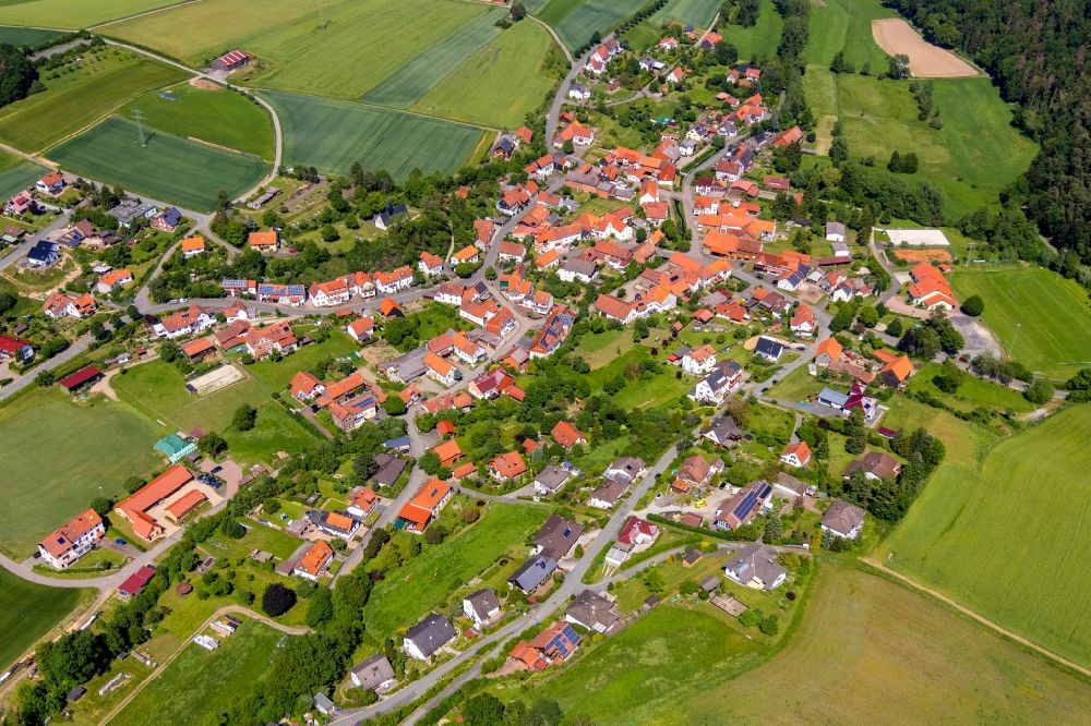 Gellershausen from above - Agricultural land and field borders surround the settlement area of the village in Gellershausen in the state Hesse, Germany