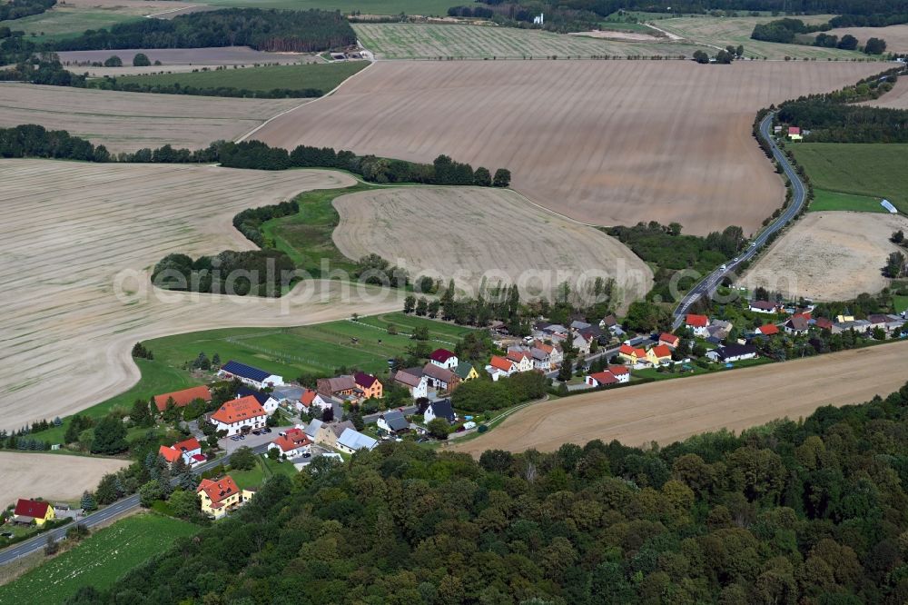 Giebelroth from above - Agricultural land and field borders surround the settlement area of the village in Giebelroth in the state Saxony-Anhalt, Germany